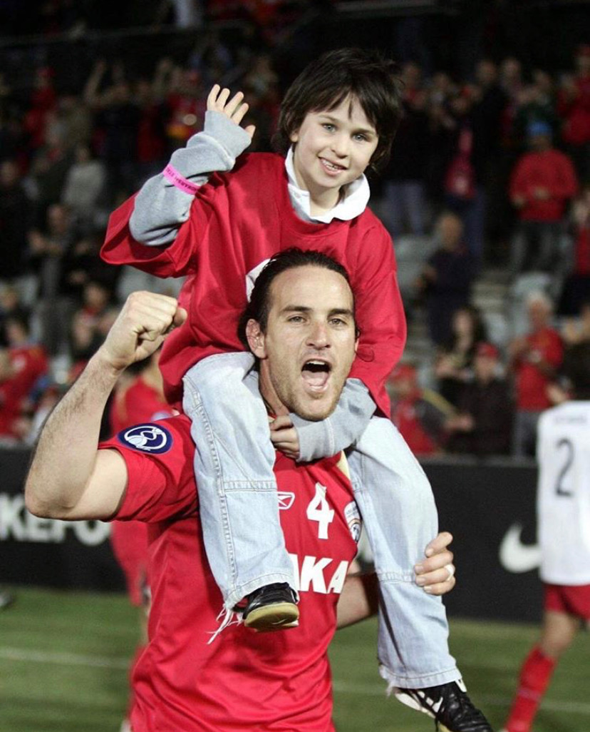 Dom Costanzo sits on top of his father Ange's shoulders following an AFC Champions League game 